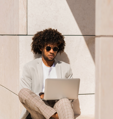 happy-african-american-businessman-working-open-air-man-suit-with-beard-using-laptop-sitting-terrace-rooftops-working-manager-technology-concept 1